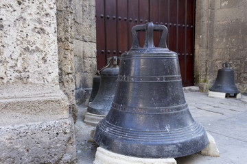 Obraz premium Old bells in front of a church portico
