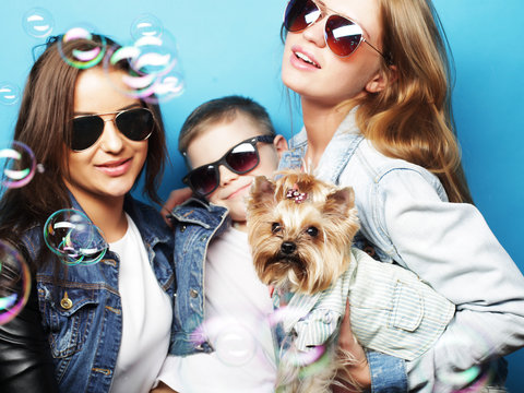 Two Sisters And Brother With Yorkshire Terrier