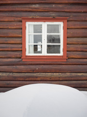 cabin window behind snowdrift