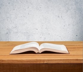 Book. Open book on wood table over grunge background