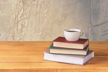 Tea. Vintage books and cup of tea on wooden table