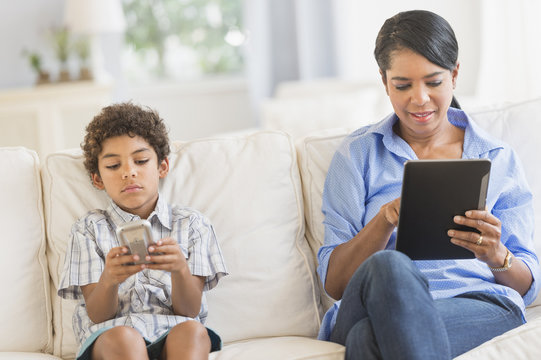 Mother and son relaxing on sofa