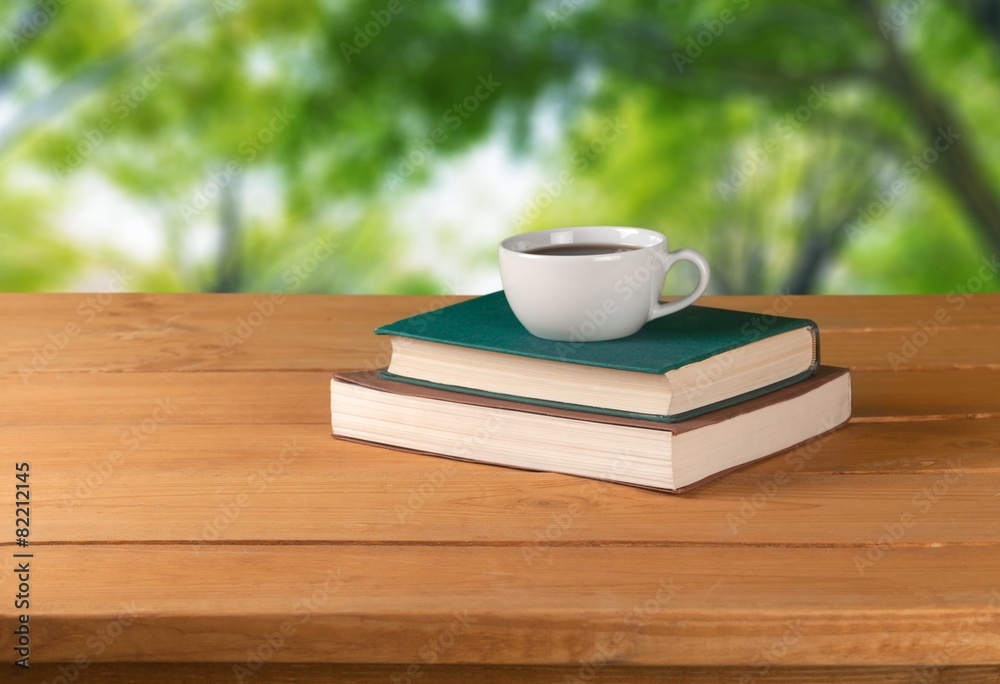 Sticker Tea. Vintage books and cup of tea on wooden table