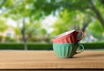 Retro. Colorful bowls on wooden table over grunge background