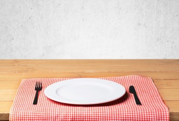 Plate. Empty plate with fork and knife on wooden table. Table