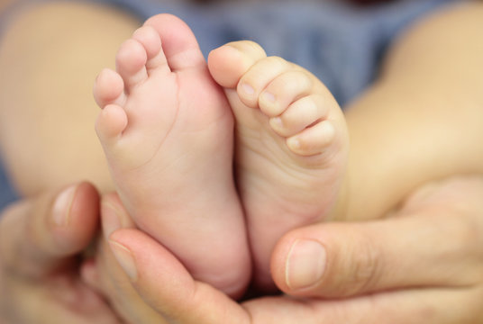 Baby feet in father hands