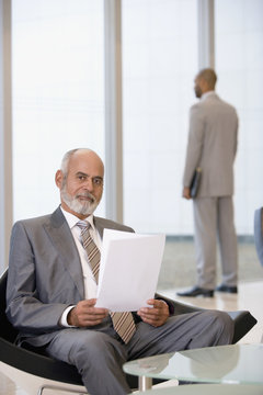 Senior African businessman holding paperwork