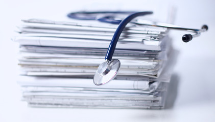 Medical stethoscope on the stack of paper
