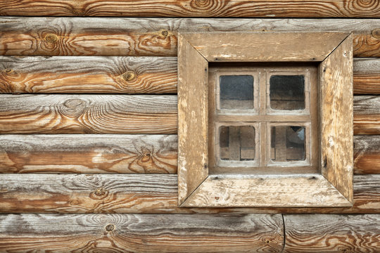 Old window  on the background of wooden walls