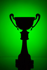 cup trophy silhouette on green background