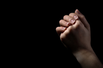 Woman praying in darkness