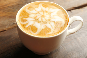 Cup of coffee latte art on wooden background