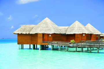 Water villas over blue ocean in Baros Maldives