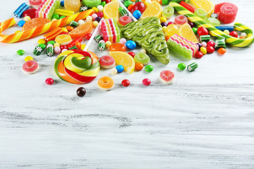 Colorful candies on wooden background