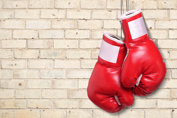 Boxing gloves over brick wall background