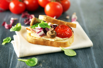 Tasty sandwich on wooden table, close up