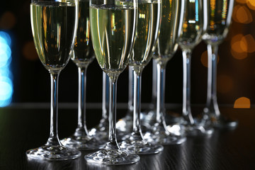 Glasses of champagne on bar background