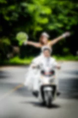Foto op Aluminium Blurry background Just married. Groom and bride on the motorcycl © nuiiko
