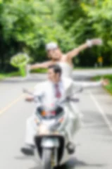 Foto op Aluminium Blurry background Just married. Groom and bride on the motorcycl © nuiiko