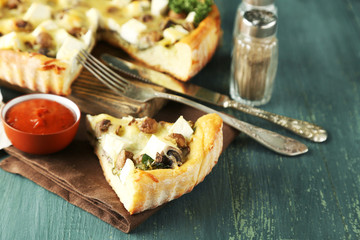 Cheese pie with mushrooms, herbs and sour creme, on color wooden table background
