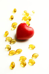 Red heart and cod liver oil, isolated on white