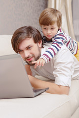 Man and boy use laptop
