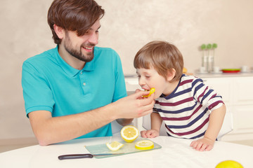 Fototapeta premium Father and son make lemonade