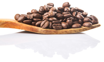 Roasted coffee beans on wooden spatula