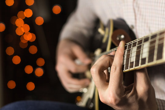 Practicing in playing guitar. Handsome young men playing guitar,