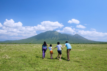 Fototapeta premium Happy family running to the mountain