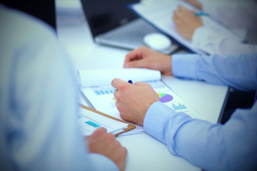 Business people sitting and writting at business meeting, in