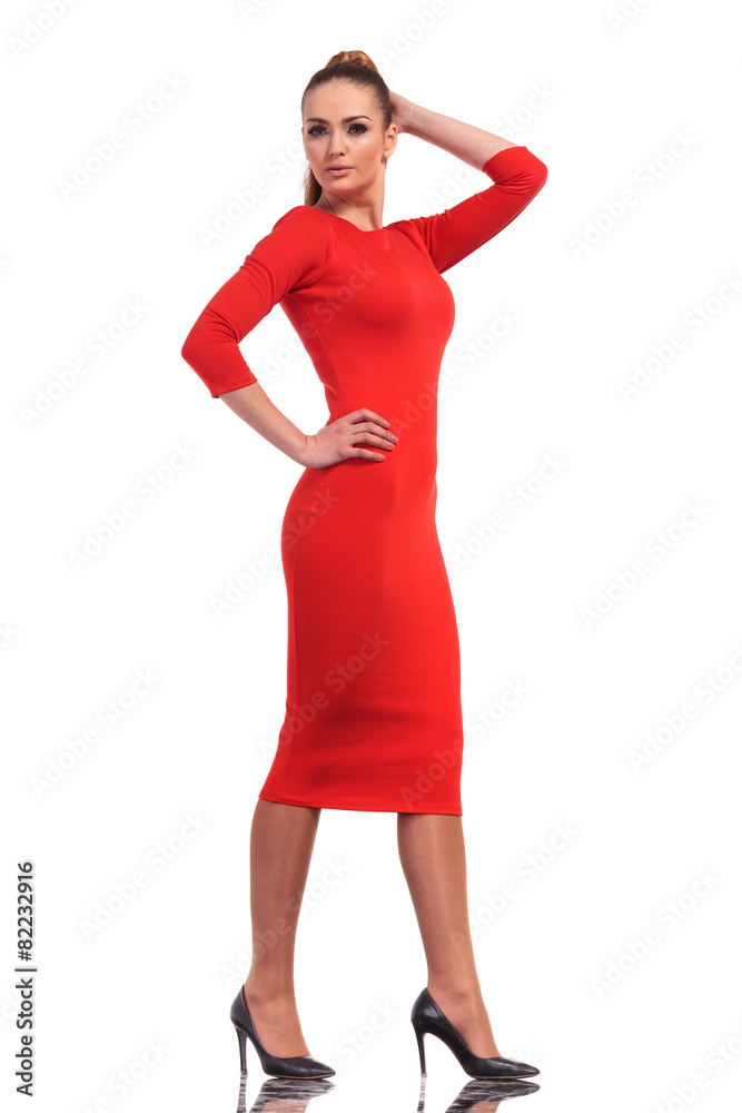 Sticker Attractive fashion woman wearing a slim red dress walking