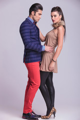 handsome young fashion man embracing his girlfriend