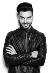 Happy young business man holding his hands crossed