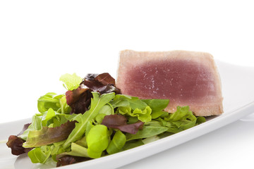 Tuna steak with salad.
