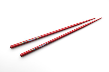 Red wooden chopsticks on white background