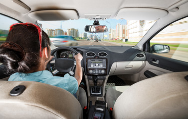 Woman behind the wheel of a car.