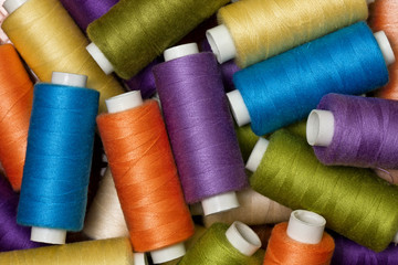 background from multi-colored spools of thread