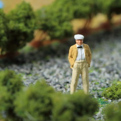 Miniature figurine man with hands in pocket