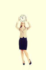 Business woman holding a clock