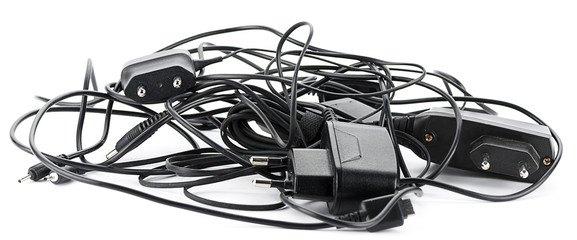 Heap of old cellular telephone chargers isolated © uwimages