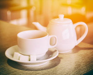 Cup of tea and teapot on the table it the cafe
