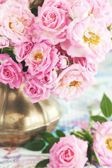 Floral composition with a pink  roses in a vintage jug .