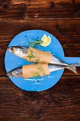 Delicious fresh mackerel fish on wooden kitchen board. 