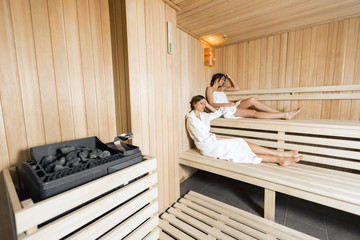 Sauna heater and girls relaxing