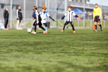 Obraz premium Blurred Kids Playing Football