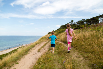 Kids walking along the coastline