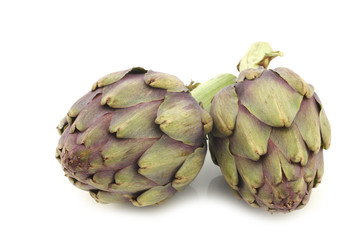 Fototapeta premium two freshly cut artichoke halves on a white background