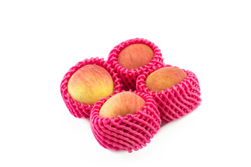 four apple with foam protection net on isolated white background