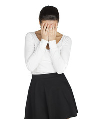 Young woman covers her face with her hands in grief